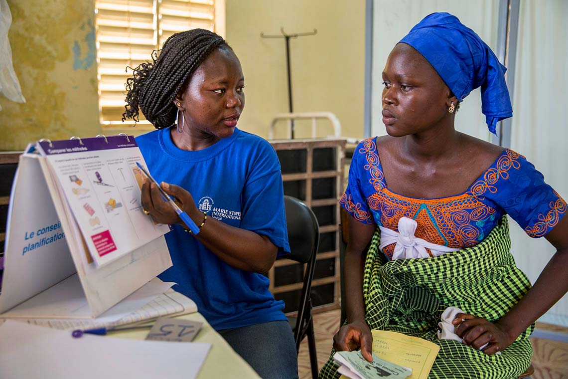 A healthcare worker discusses family planning options with a young woman